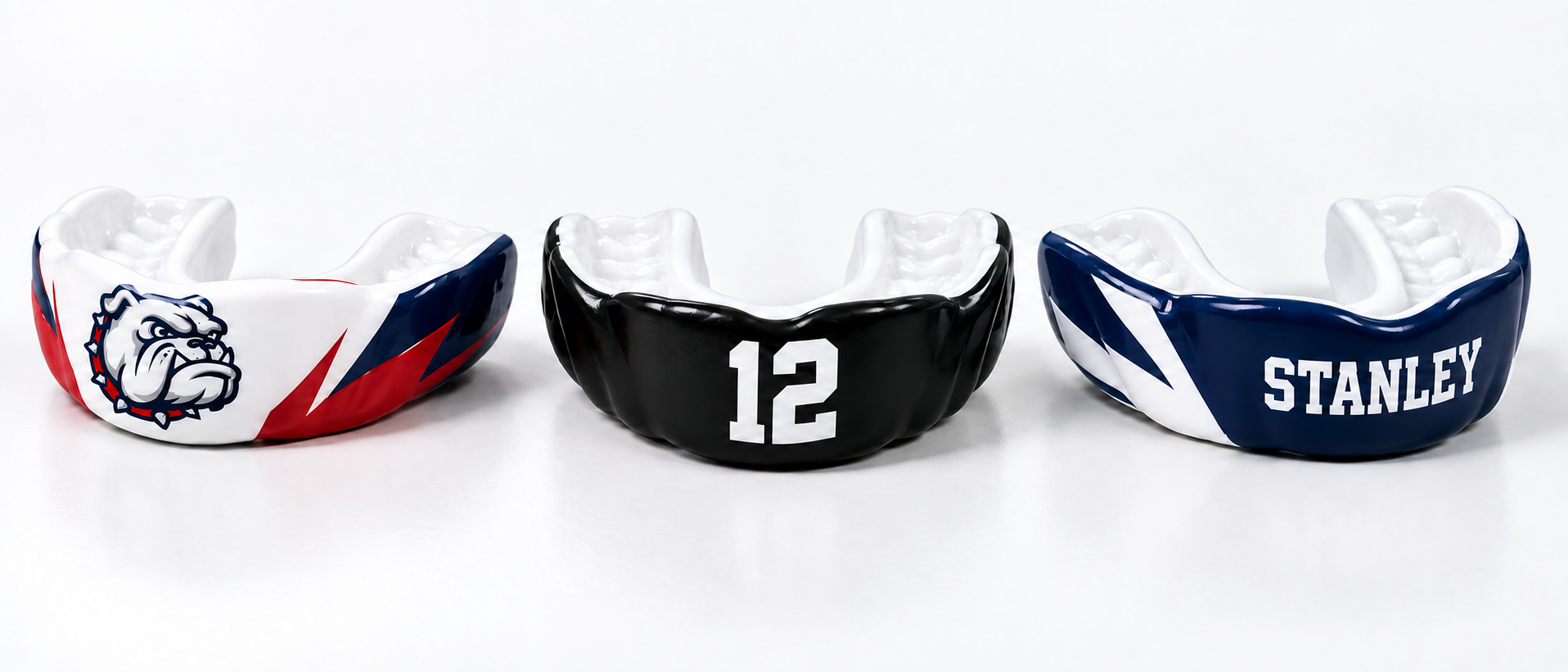 Three custom mouthguard personalization examples: a generic bulldog design, a black guard with number 12, and a guard personalized with the name Stanley